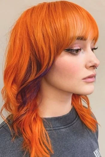 Fiery Orange Wolf Cut with Blunt Bangs