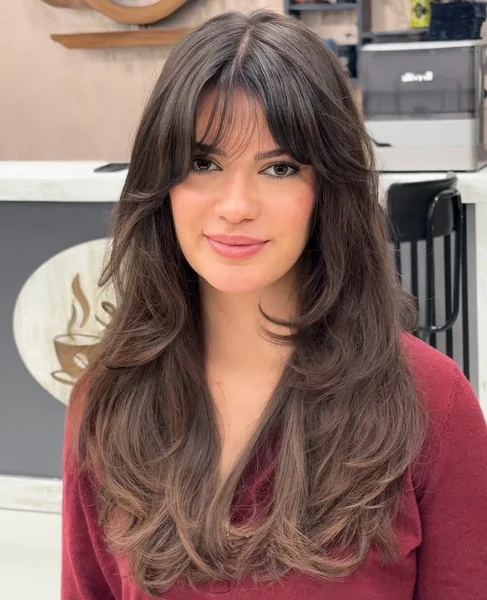 Long, Voluminous Butterfly Cut with Wispy Bangs