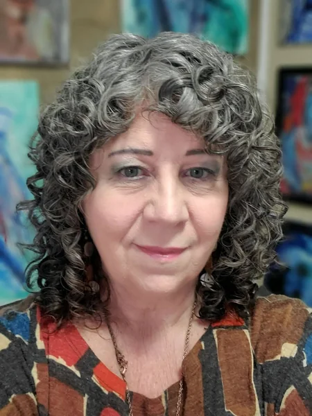 Shoulder-Length Gray and Brown Curls with Soft Bangs