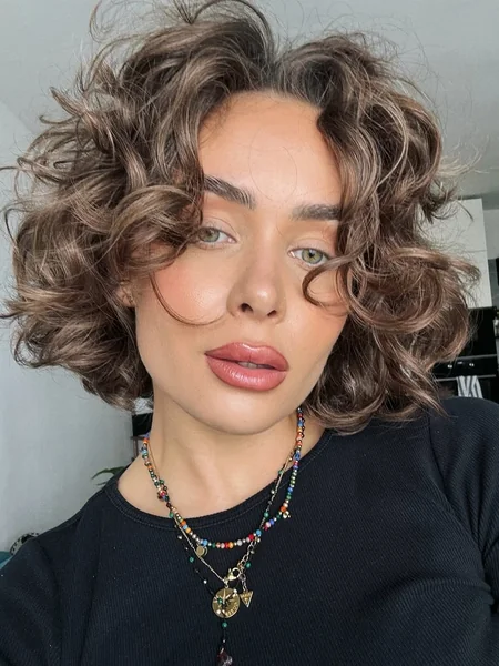 Voluminous Curly Bob with Soft Layered Fringe