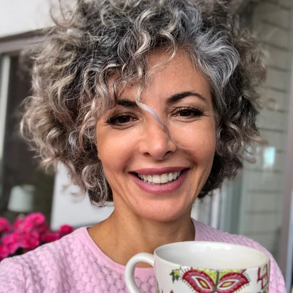 Voluminous Short Curly Cut with Gray Highlights