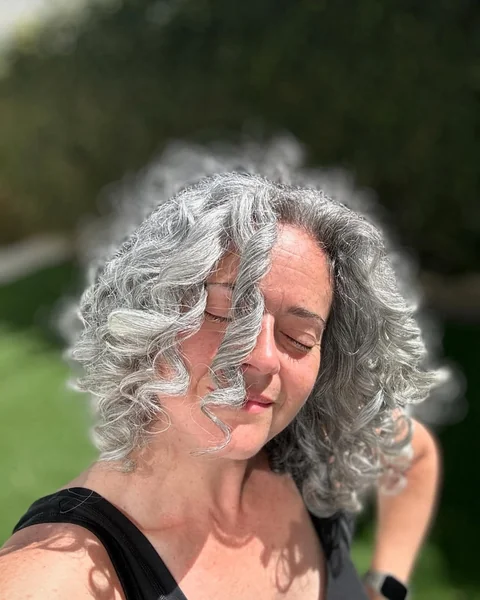 Voluminous Silver Gray Bob with Looser Curls