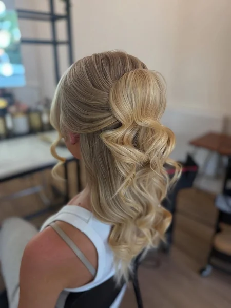 Glamorous High Half-Updo with Soft Face-Framing Wispies
