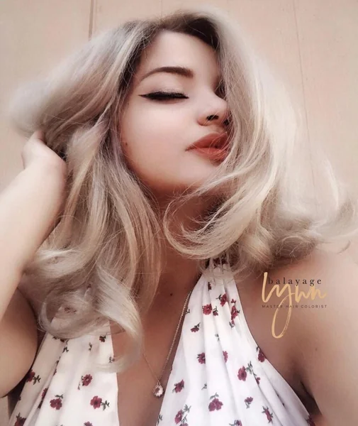 Icy Blonde Voluminous Butterfly Cut with Waves