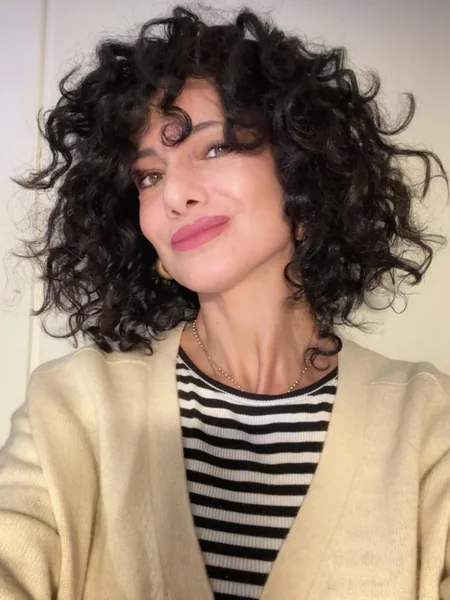 Chic Dark Curly Bob with Soft Face-Framing Fringe