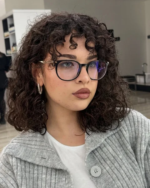 Dark Bob with Tightly Coiled Bangs and Shoulder Cut