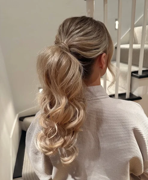 Effortless Wavy Blonde Ponytail with Hidden Wrap Detail