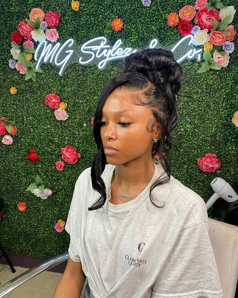 Effortlessly Chic High Messy Bun with Face-Framing Curls