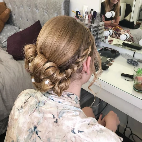 Elegant Low Coiled Chignon with Delicate Side Braid