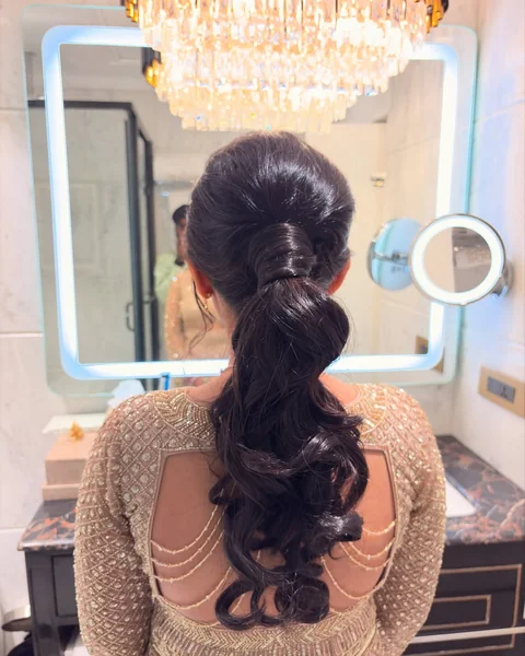 Elegant Low Ponytail with Wrapped Base and Barrel Curls