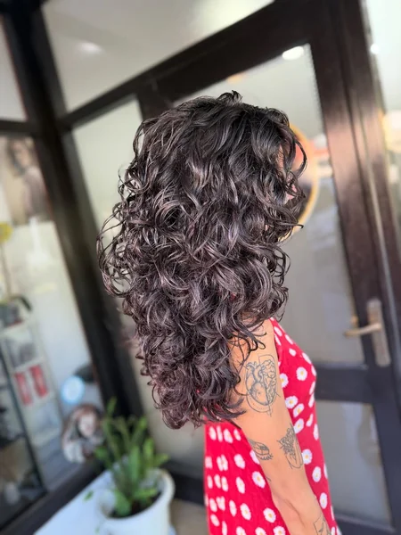 Glossy Dark Curly Hair with Voluminous Butterfly Layers