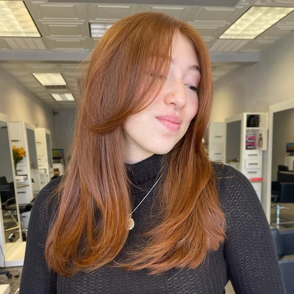 Glowing Copper Butterfly Layers with Curtain Bangs