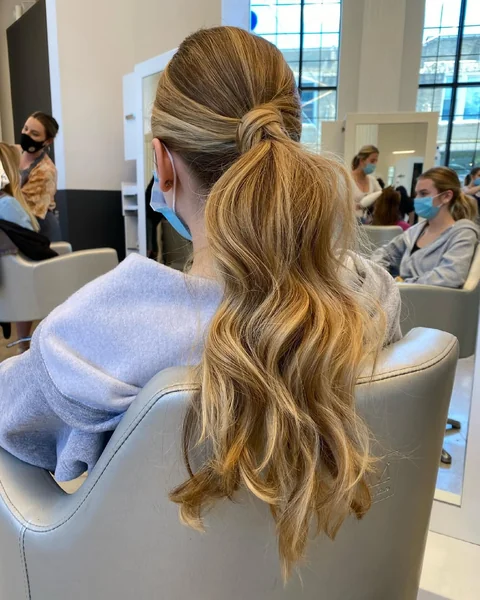 Modern Wrapped Ponytail with Loose Textured Waves