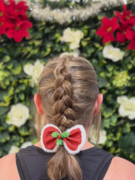 Neat French Braid Finished with a Holly Christmas Bow