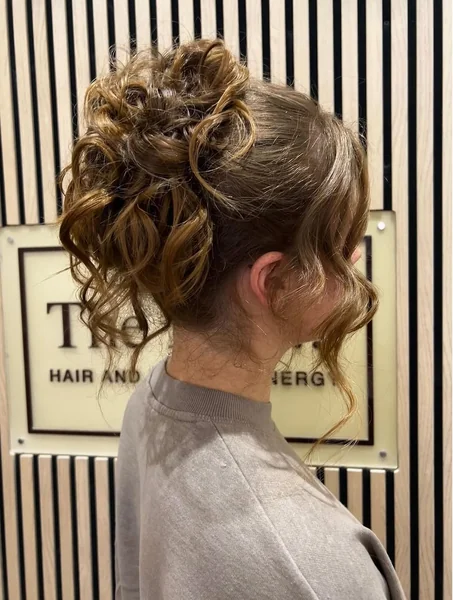 Romantic Curly High Bun with Face-Framing Tendrils