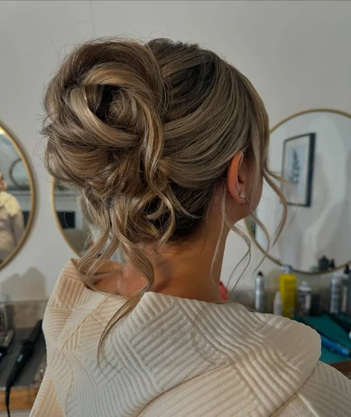 Romantic Messy Updo with Soft Face-Framing Tendrils