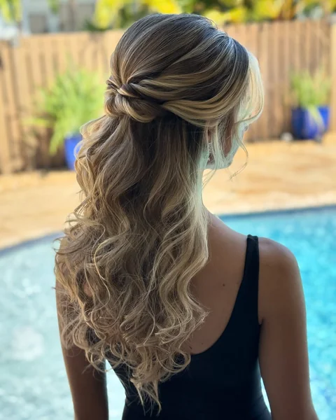 Romantic Wavy Half-Up Prom Style with Golden Highlights