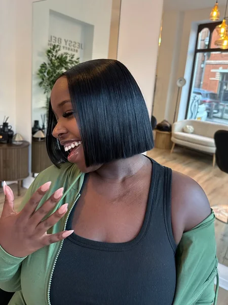 Sleek, Ear-Length Black Bob with Precise Edges