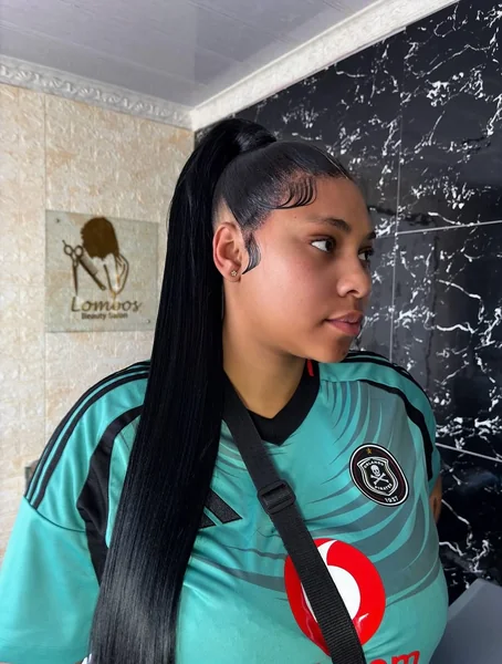 Sleek High Ponytail with Voluminous Wavy Ends