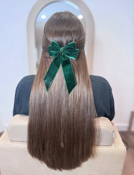 Sleek Long Hair with a Classic Emerald Velvet Bow