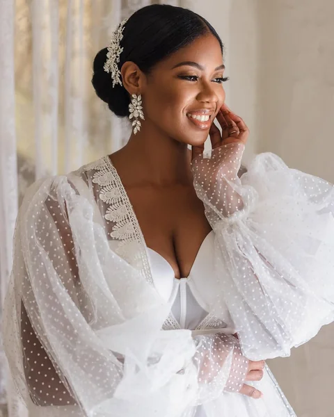 Sleek Low Chignon with a Dramatic Side Hair Piece