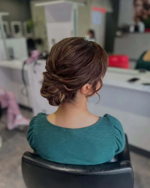 Sleek Polished Dark Brunette Low Twisted Chignon