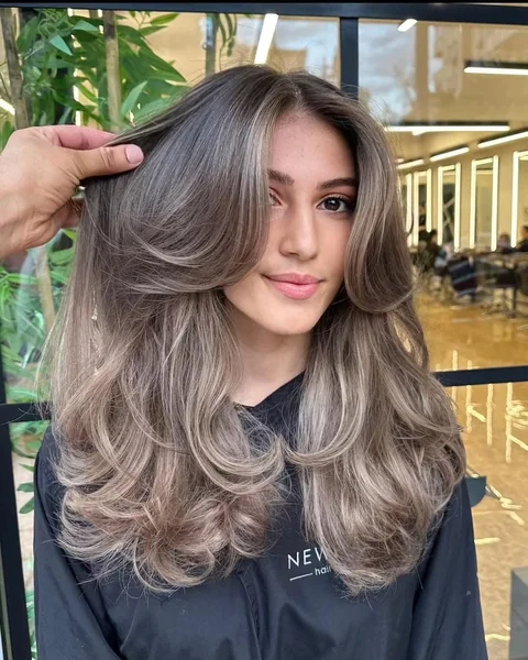 Smoky Blonde Butterfly Layers with Dramatic Curtain Bangs