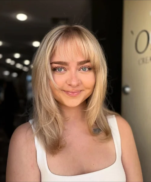 Soft Blonde Layers with Light Wispy Bangs