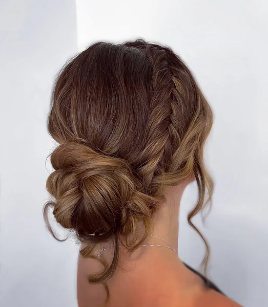 Soft Textured Braided Low Updo with Face-Framing Curls