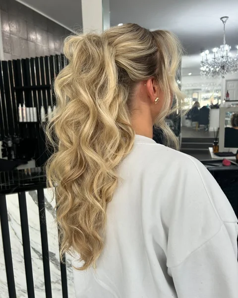 Textured High Ponytail with Messy Curls and Volume