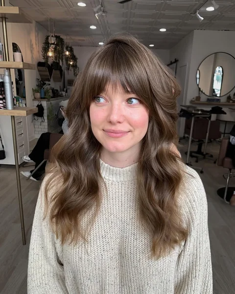 Voluminous Blowout with Face-Framing Curtain Bangs