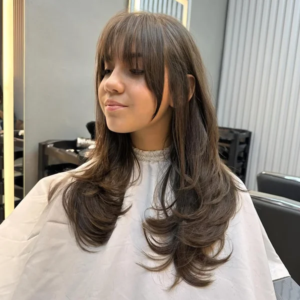 Voluminous Brunette Butterfly Cut with Soft Curtain Bangs