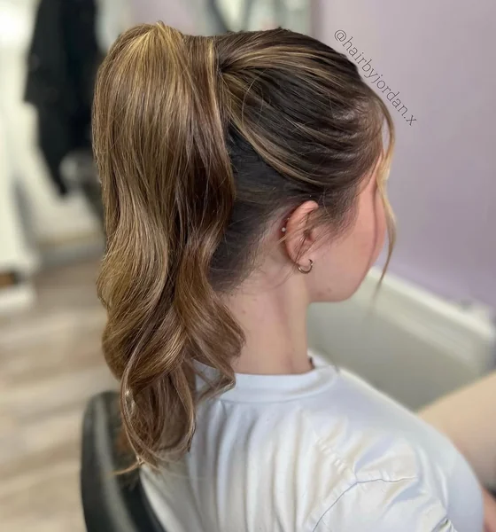 Voluminous High Ponytail with Face-Framing Waves