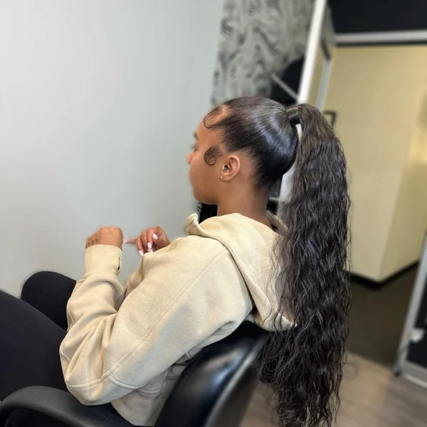Sleek High Ponytail with Voluminous Deep Wave Curls