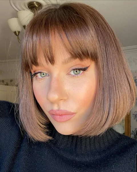 Sleek Mauve-Brown Inverted Bob with Soft Wispy Bangs