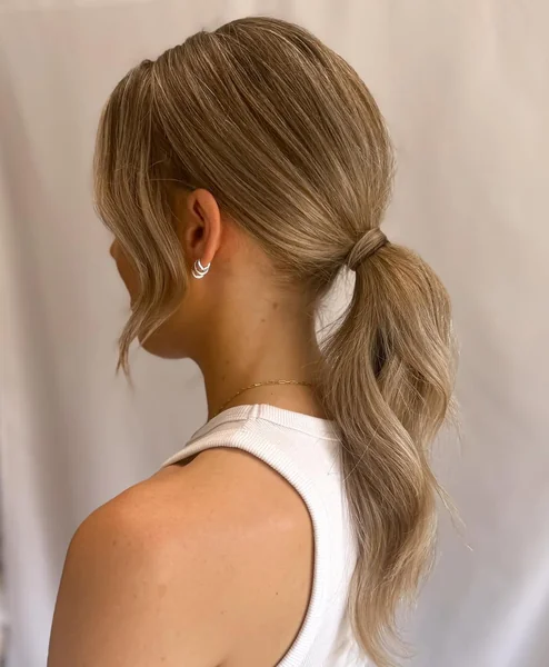 Soft Wavy Low Ponytail with Face-Framing Tendrils