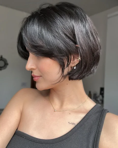 Sophisticated Low Chignon with Soft Face-Framing Tendrils