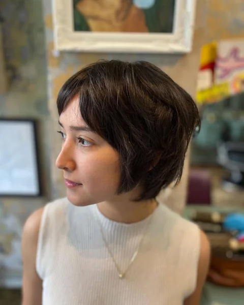 Soft Charcoal Wavy Bob with Side-Swept Bangs