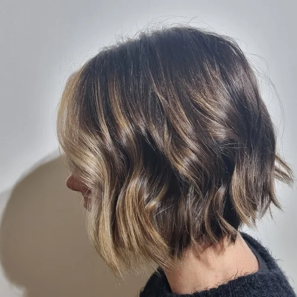 Glossy Brunette Pixie with Long Side-Swept Fringe