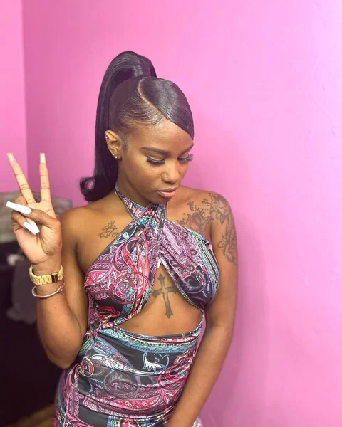 Sleek Base Ponytail with Voluminous Corkscrew Curls