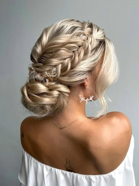 Boho-Chic Braided Crown Bun with Floral Accessories