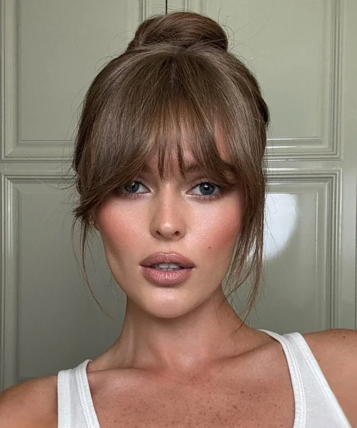 Chic Blonde Top Knot with Soft Wisps
