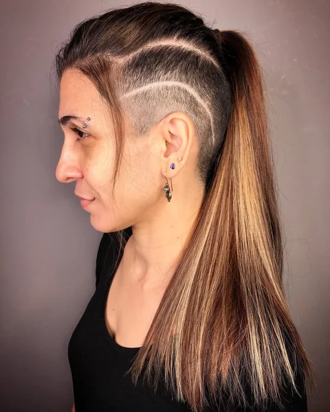 Edgy Undercut Ponytail with Artistic Shaved Lines