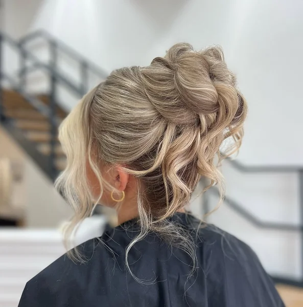 Effortless Side-Parted Messy Bun with Golden Waves