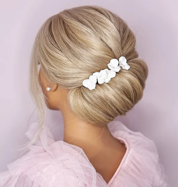 Elegant Pearl-Encrusted Low Bun with Intricate Twists