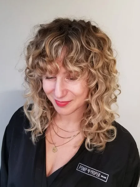 Honey Blonde Cloud Curls with Soft Bottleneck Bangs