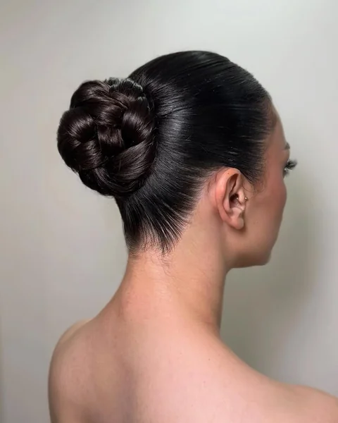 Intricate Braided Low Bun on Sleek Dark Hair