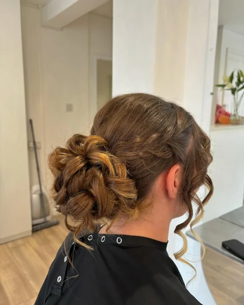 Intricate Braided Low Bun with Face-Framing Tendrils