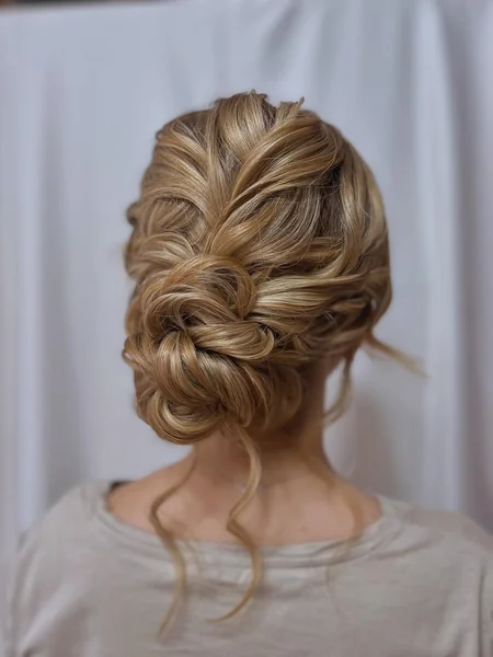 Intricate Woven Low Bun with Soft Golden Highlights