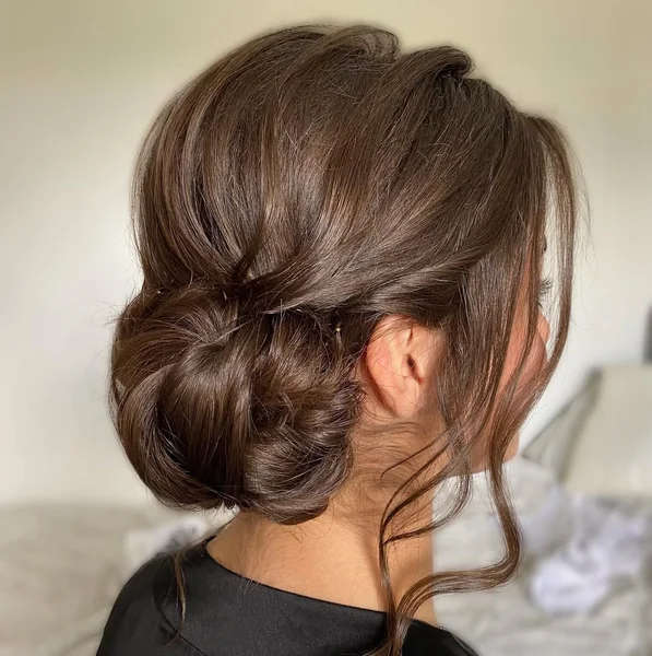 Low Intricate Chignon with Floral Satin Accents